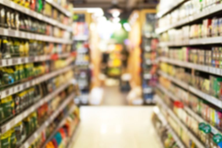 Grocery Store Aisle Abstract Blurred Background With Products On Shelves
